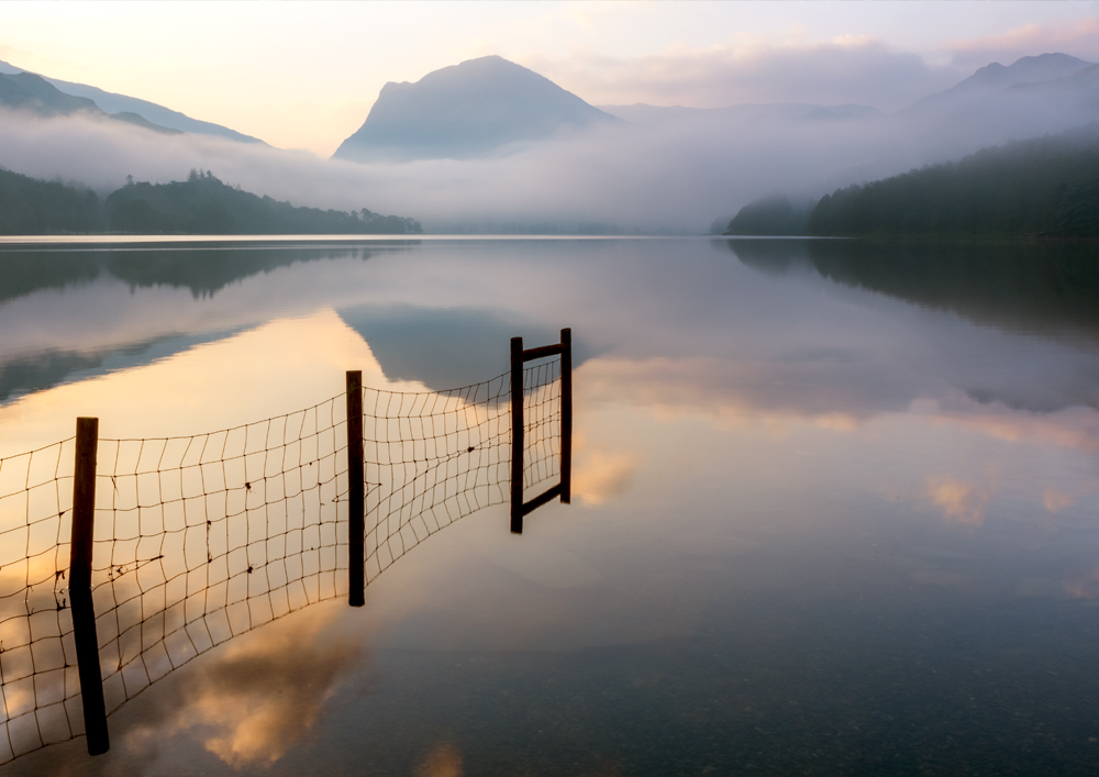 Lake District Photography showing a misty sunrise over Buttermere lake with Haystacks mountain in the distance. Wall Art