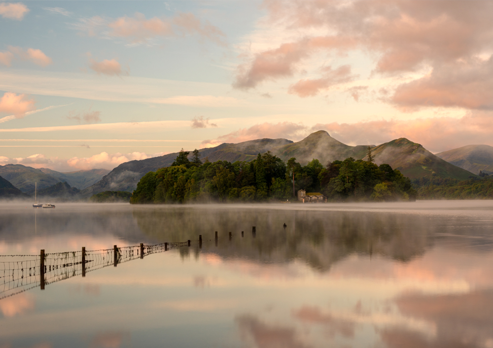 Northern Wild Landscape Photography - Lake District Photography showing a misty sunrise over Derwentwater with Derwent Isle emerging from the mist. From Crow park in Keswick, UK